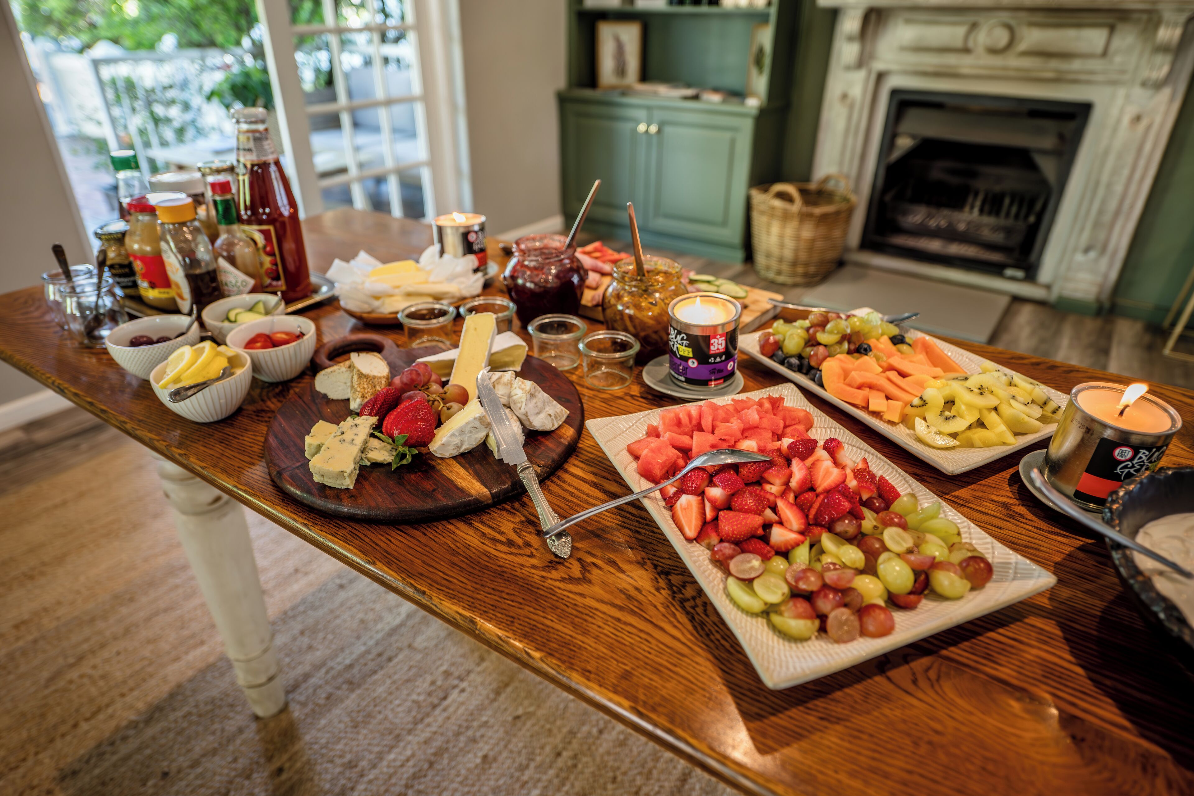 A wooden dining table with various food items and condiments.