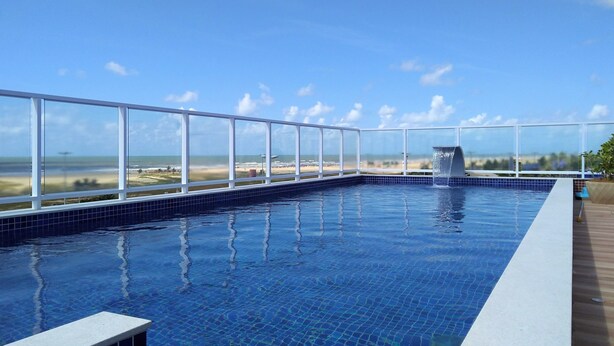 A rooftop infinity pool with a clear view of the beach and ocean. - Simas Praia Hotel (Aracaju)
