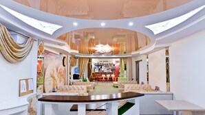 A modern interior with a central seating area, a bar, and a reception desk. - Hotel Olsi (Chisinau)
