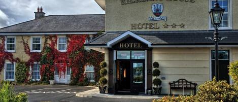 The exterior of the Kilkenny House Hotel with a prominent entrance, a traditional facade, and a clear view of the surrounding area.