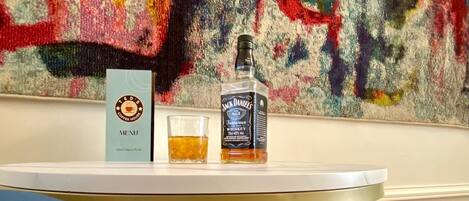 A table with a menu, a bottle of Jack Daniel's Tennessee Whiskey, and a glass of whiskey.
