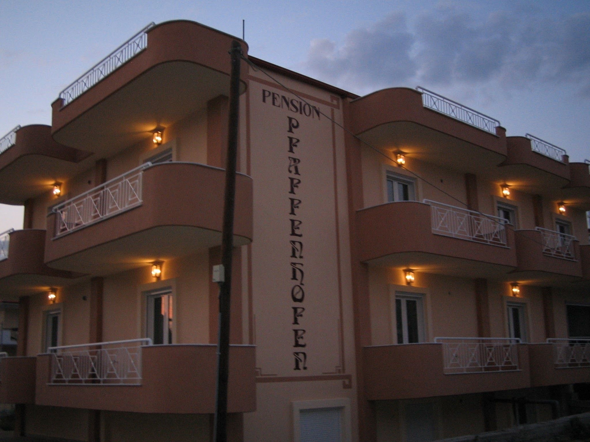 A multi-story building with balconies and a sign reading "Pension Franzloper".