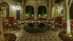 A courtyard with a central fountain, seating areas, and arched walkways. - Riad Dar Sara (Marrakech)