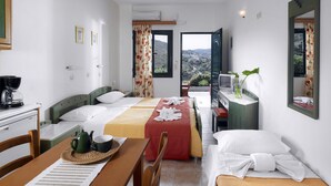 A hotel room with two beds, a dining area, a TV, and a balcony with a view.