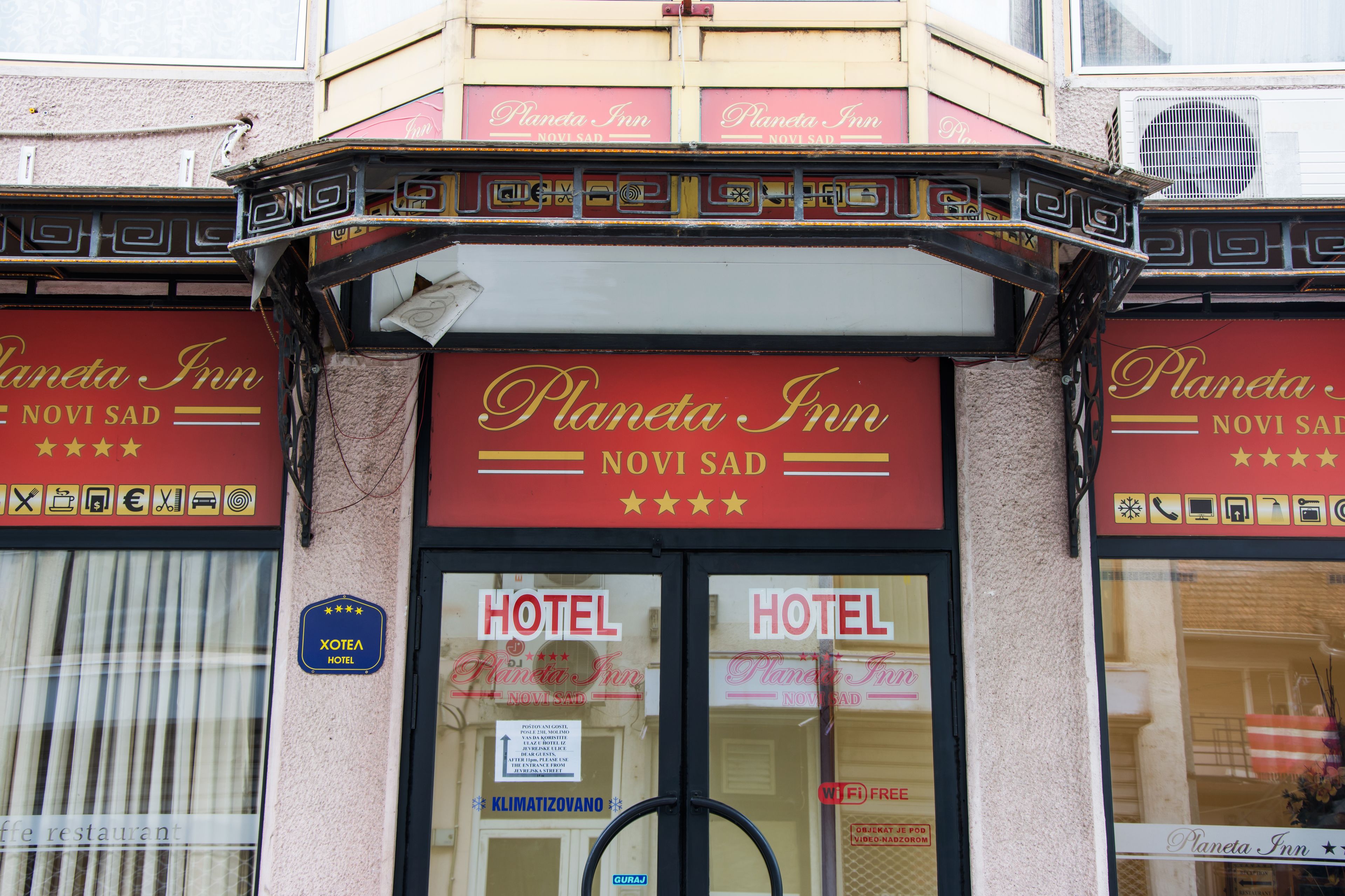 The exterior of the Planetia Inn with a sign indicating it is a hotel.