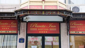The exterior of the Planetia Inn with a sign indicating it is a hotel.