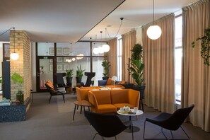 A modern lounge area with a sofa set, chairs, and a coffee table.