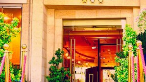 The entrance to the Torino Hotel with a prominent sign above the door. - Torino Amman Hotel (Amman)