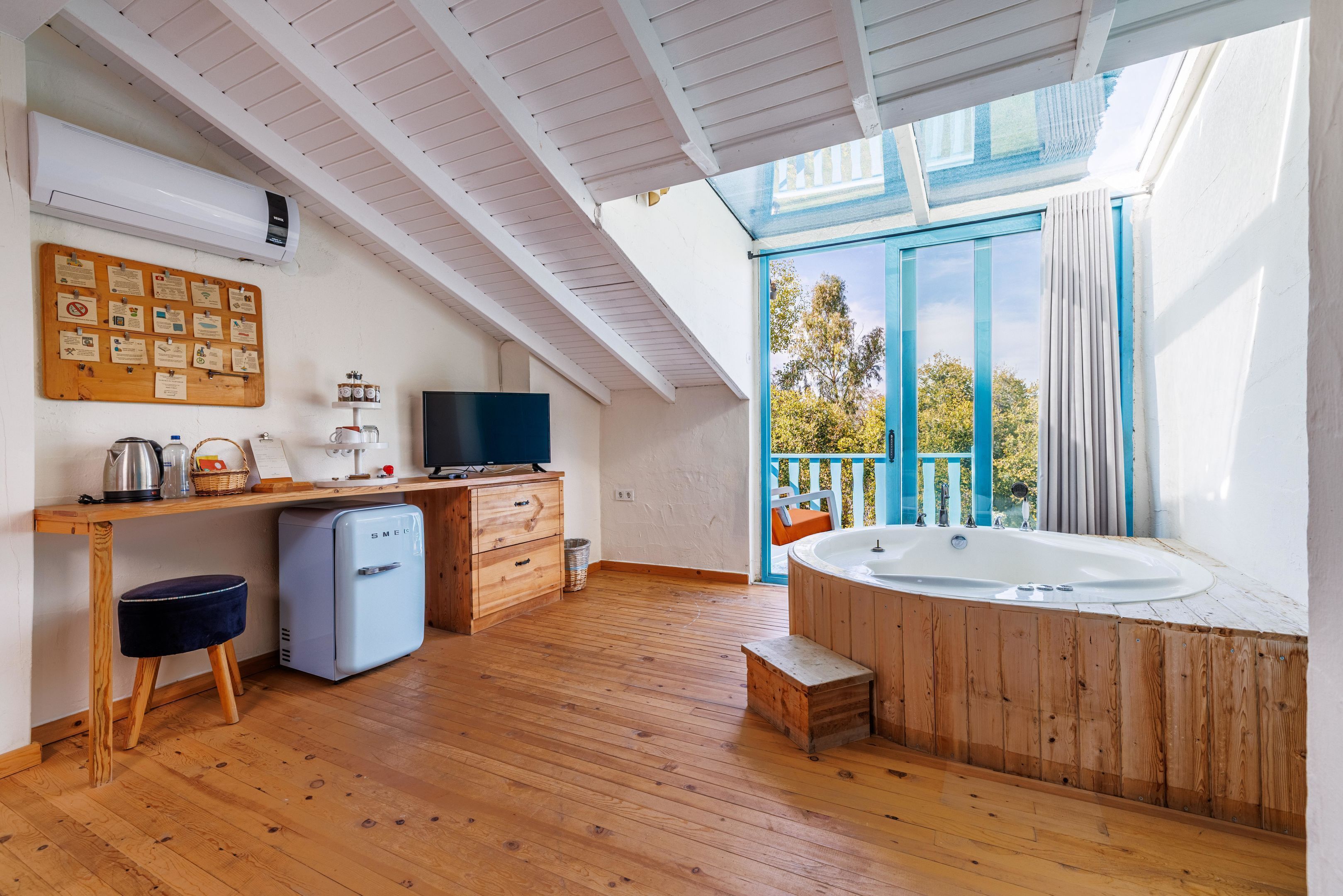 A modern bathroom with a wooden vanity, a sink, and a bathtub.