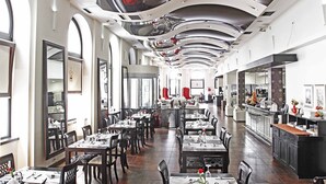 A spacious restaurant with high ceilings, large windows, and a modern interior design. - Hotel Central (Sarajevo)