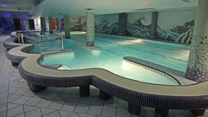 An indoor swimming pool with tiled walls and benches. - Hotel Central (Sarajevo)