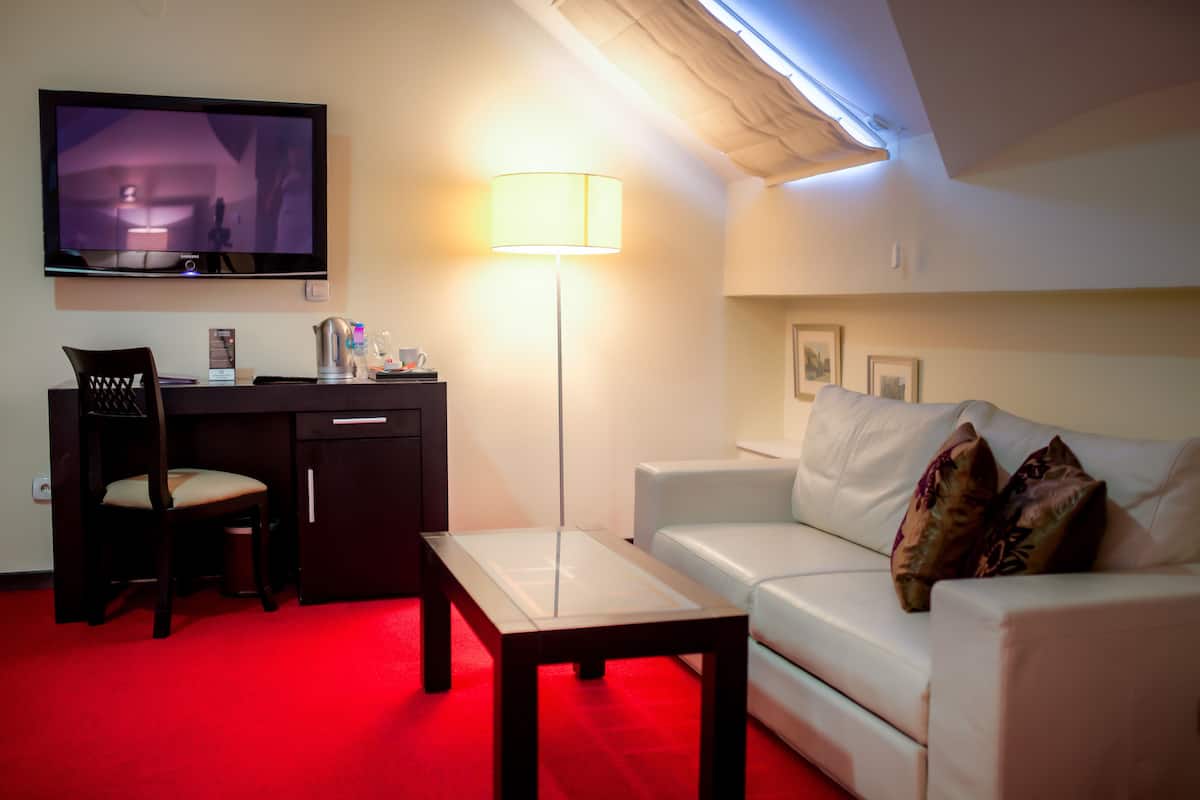 junior suite | living area | 55-inch lcd tv with cable channels, tv