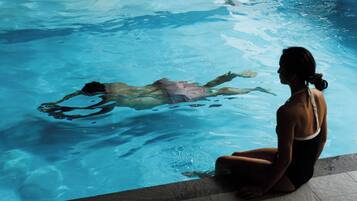 A person sitting by a swimming pool.