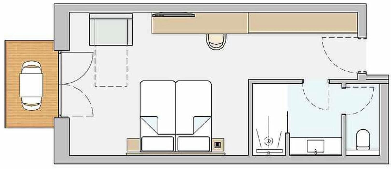 Ein Hotelzimmer mit Bett, Schreibtisch, Stuhl, kleinem Tisch und Bad.