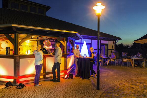 A food stall with a sign reading "MOËT & CHANDON" and a person standing at the counter.