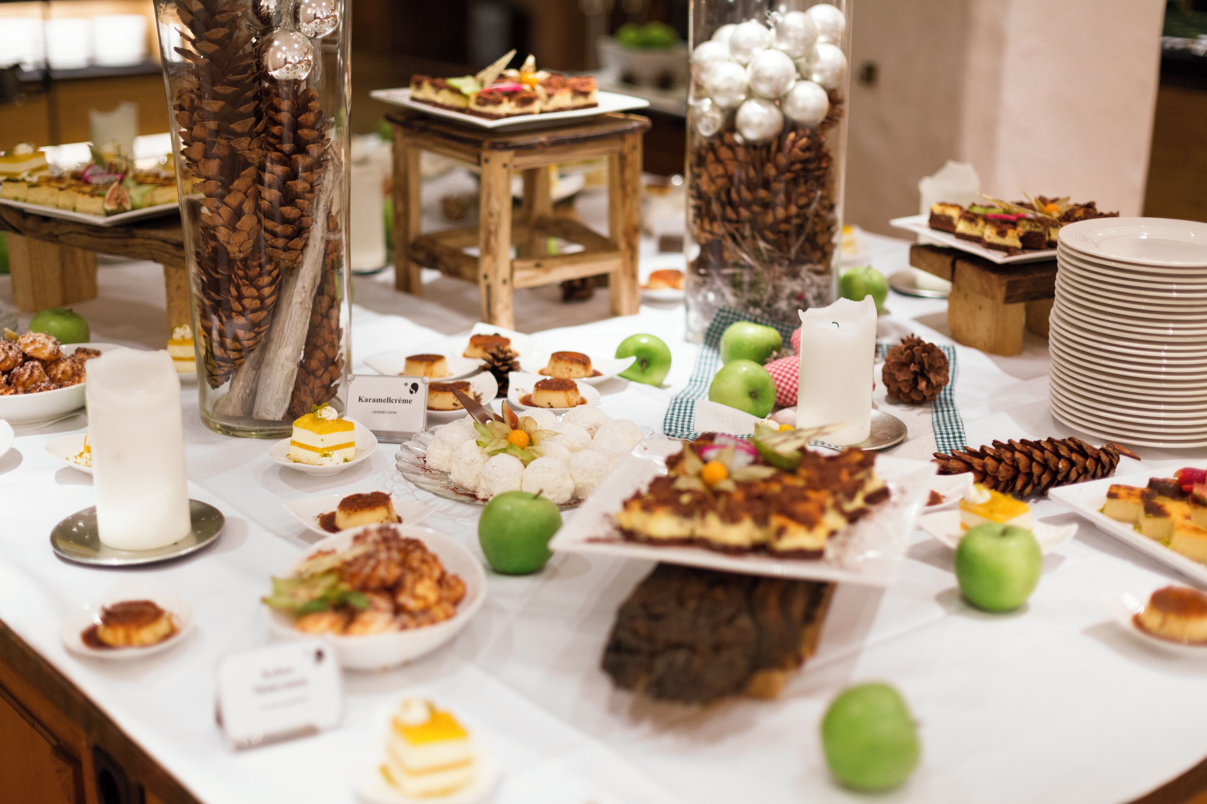 A buffet table with various desserts and fruits.