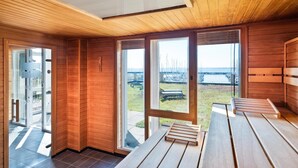 A modern interior with wooden walls and large windows.