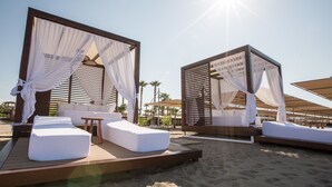 A beachside resort with two canopy beds, wooden deck, and outdoor seating area. - TUI BLUE Palm Garden - All inclusive (Manavgat)
