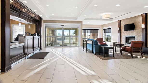 A hotel lobby with a reception desk, seating area, and a fireplace. - Comfort Inn Hebron-Lowell Area (Hebron)