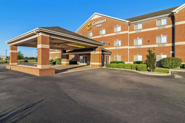 A Comfort Inn hotel with a covered entrance, brick exterior, and multiple windows.