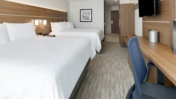 A hotel room with two beds, a desk, a chair, a television, and a framed picture on the wall. - Holiday Inn Express & Suites San Antonio NW near SeaWorld by IHG (San Antonio)