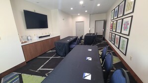 A conference room with a long table, chairs, a TV, and framed artwork on the walls. - Holiday Inn Express & Suites San Antonio NW near SeaWorld by IHG (San Antonio)