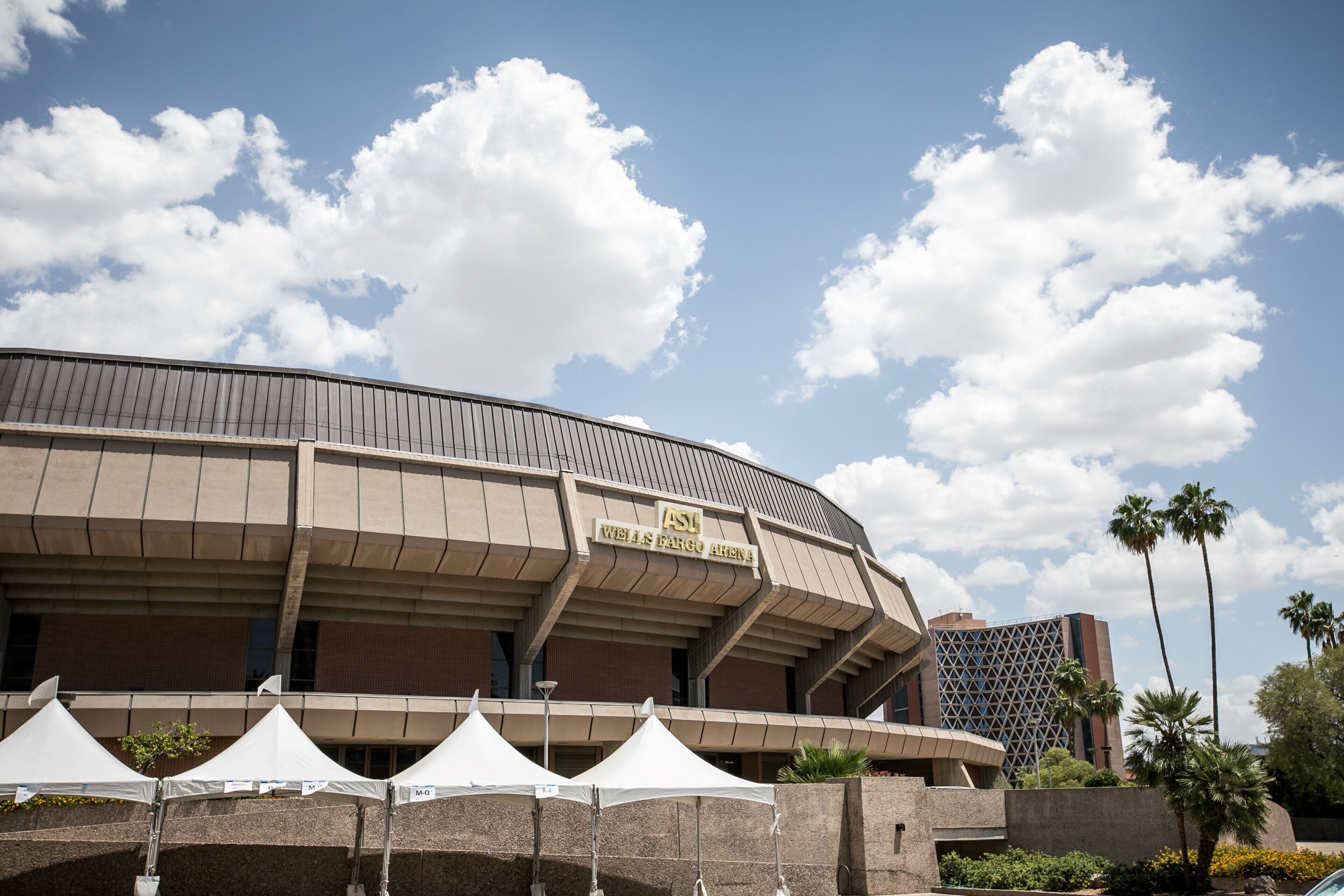 A stadium with a curved roof and a sign reading "ASU Wells Fargo Arena".