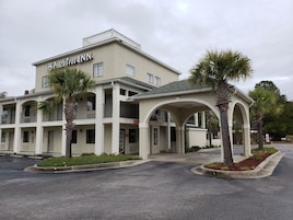 A two-story building with a sign reading "PachTree Inn".