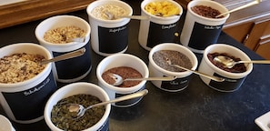 A variety of food items in labeled containers on a kitchen counter.