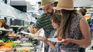 Un bufé con distintos alimentos y utensilios.