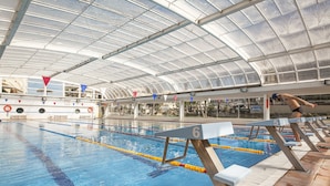 Una piscina techada con carriles de natación y trampolines.