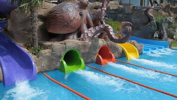 A water park with slides and a large octopus statue.