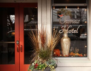 Canas Hotel features a charming exterior with a prominent sign and seasonal decorations.