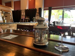 Enjoy a drink at the bar, where wine and lanterns set the scene.