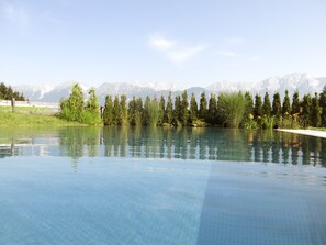 Una piscina nítida amb un paisatge de muntanyes al fons.