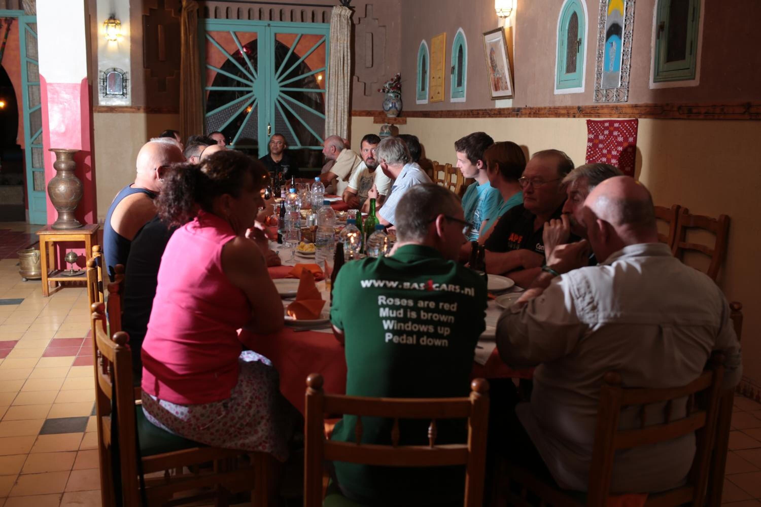 A group of people dining at a table in a restaurant with a traditional interior.
