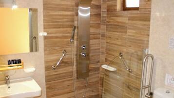 A bathroom with a shower, sink, and toilet.