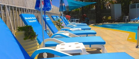 Seasonal outdoor pool, pool umbrellas, pool loungers