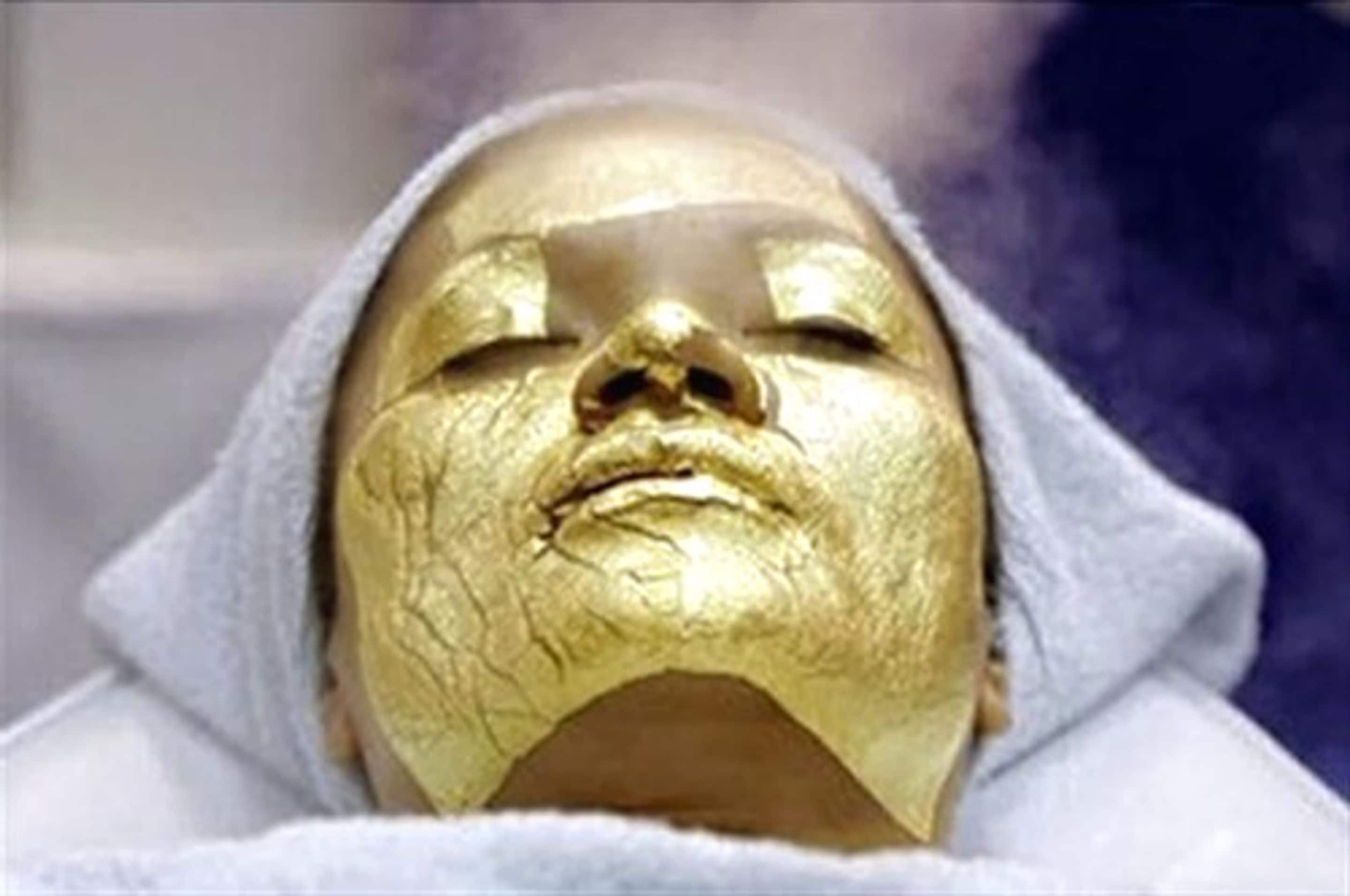 A person wearing a gold mask.