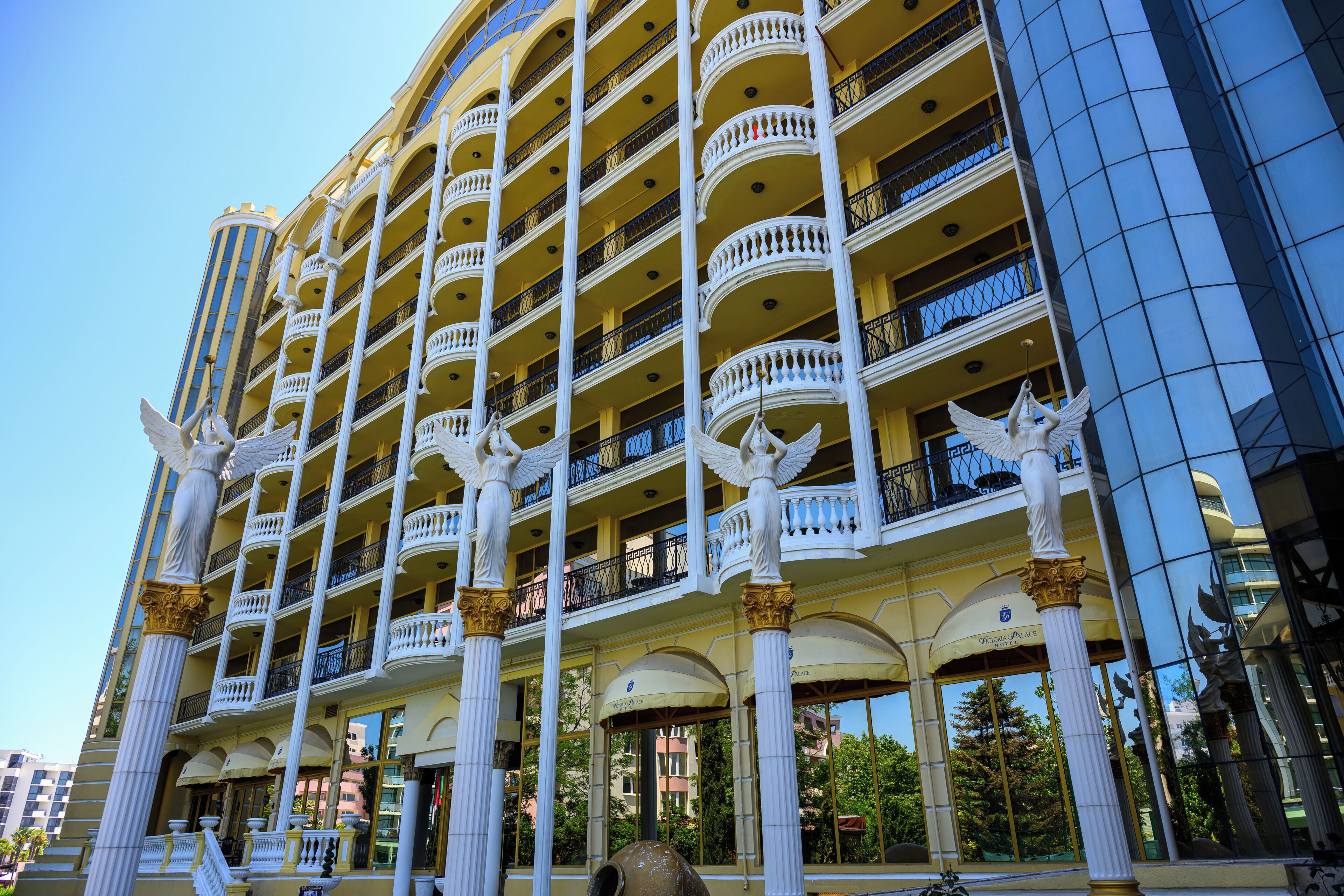 A multi-story hotel with balconies and columns.