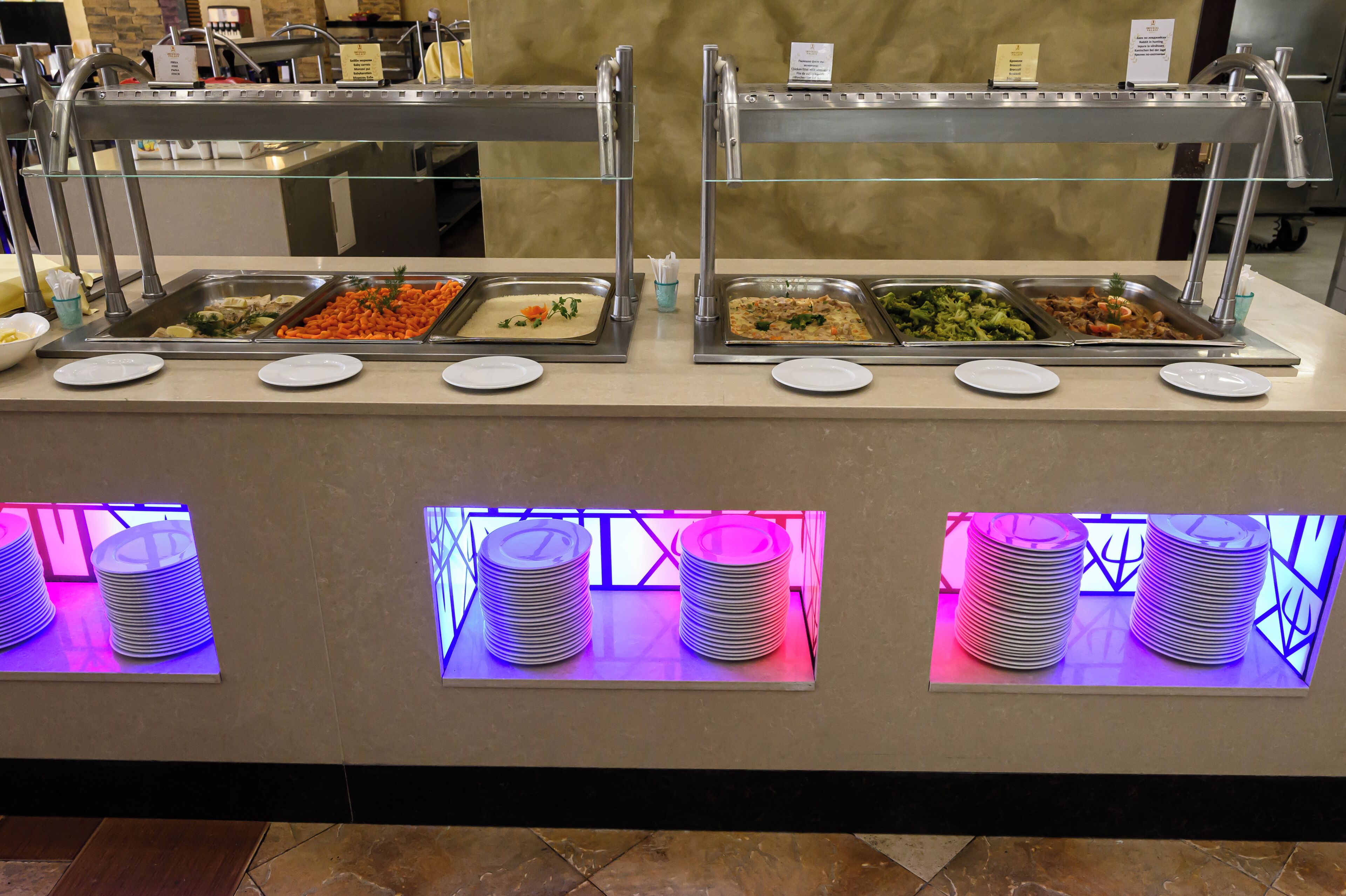 A buffet setup with multiple food stations and plates.