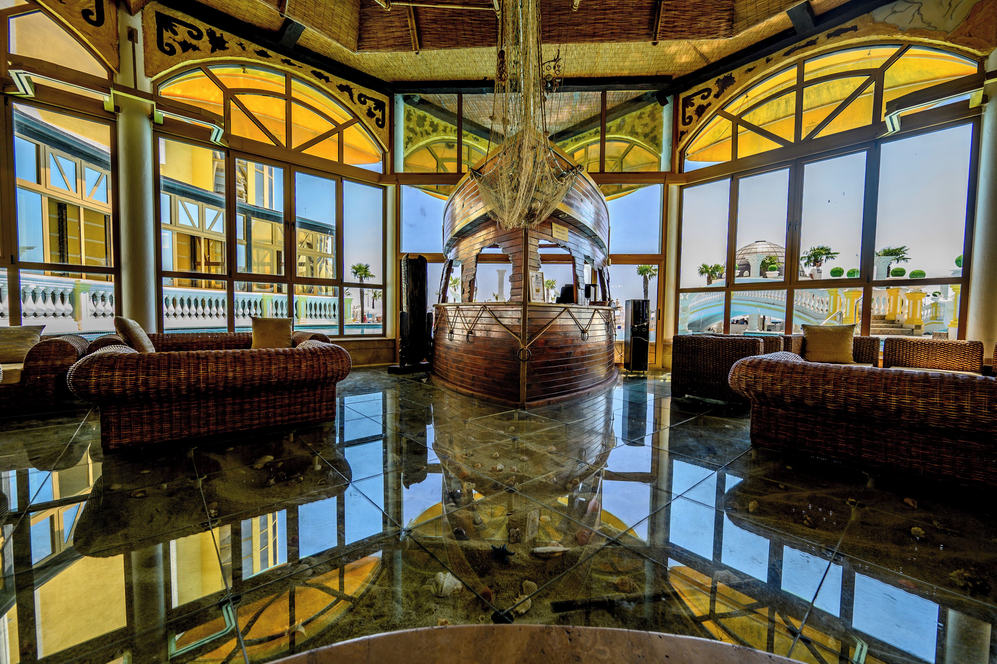 A spacious lobby with a large central aquarium, comfortable seating areas, and large windows offering views of the surrounding area.