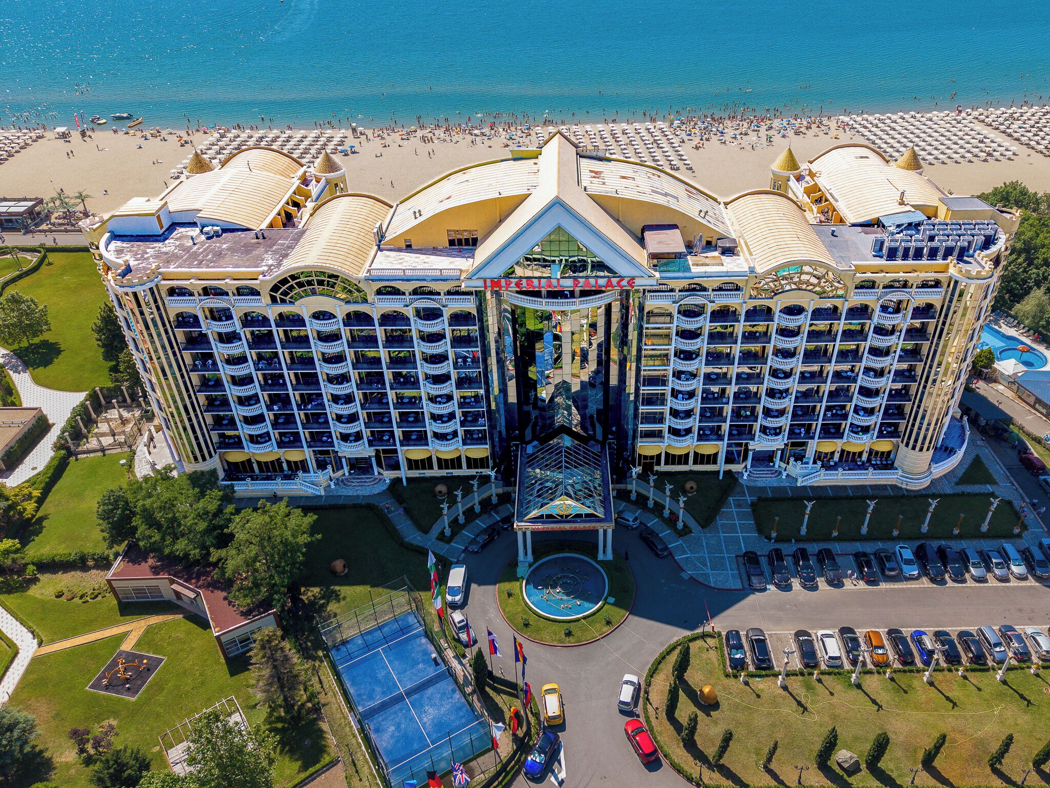 A large hotel with multiple balconies and a central courtyard.
