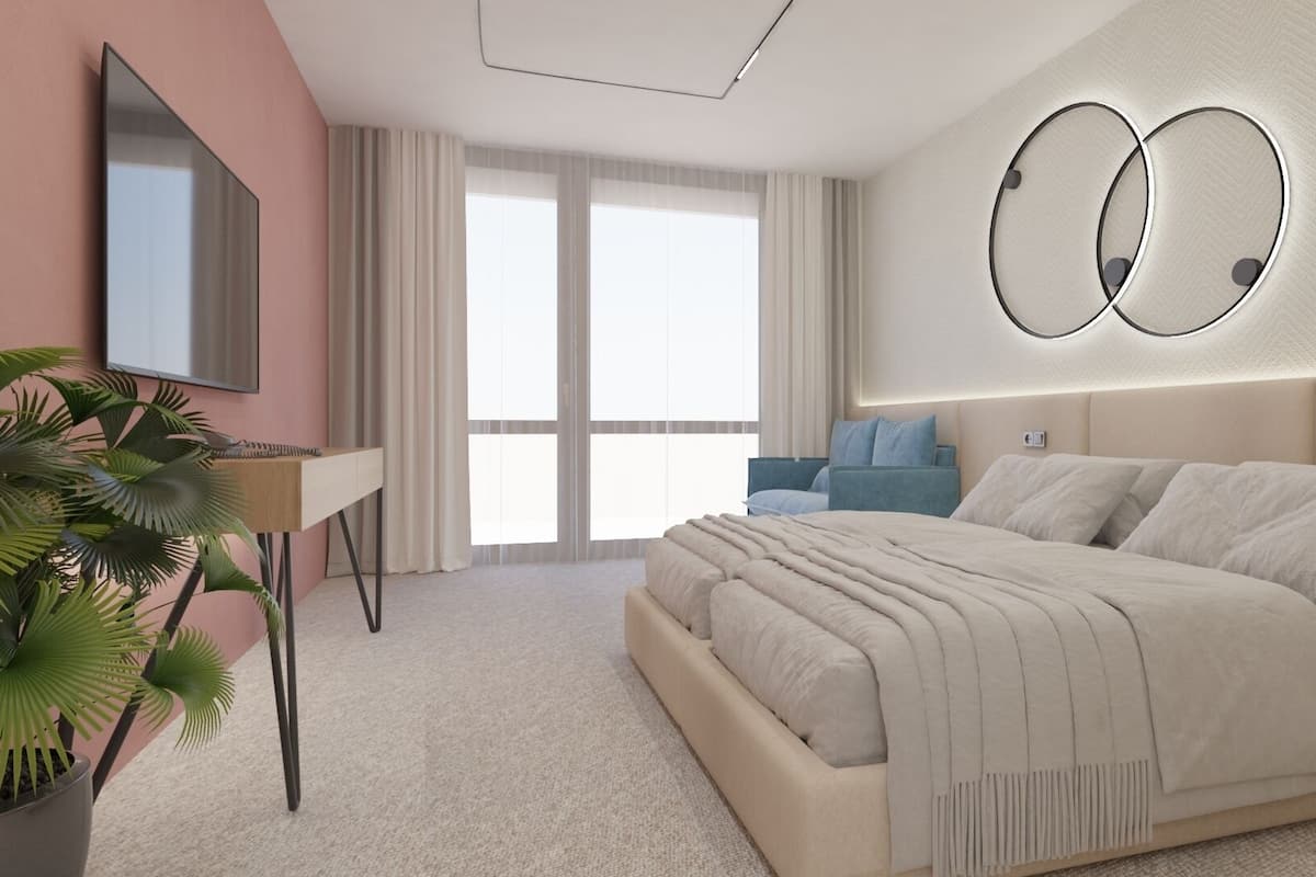 A modern bedroom with a large bed, a desk, and a TV.