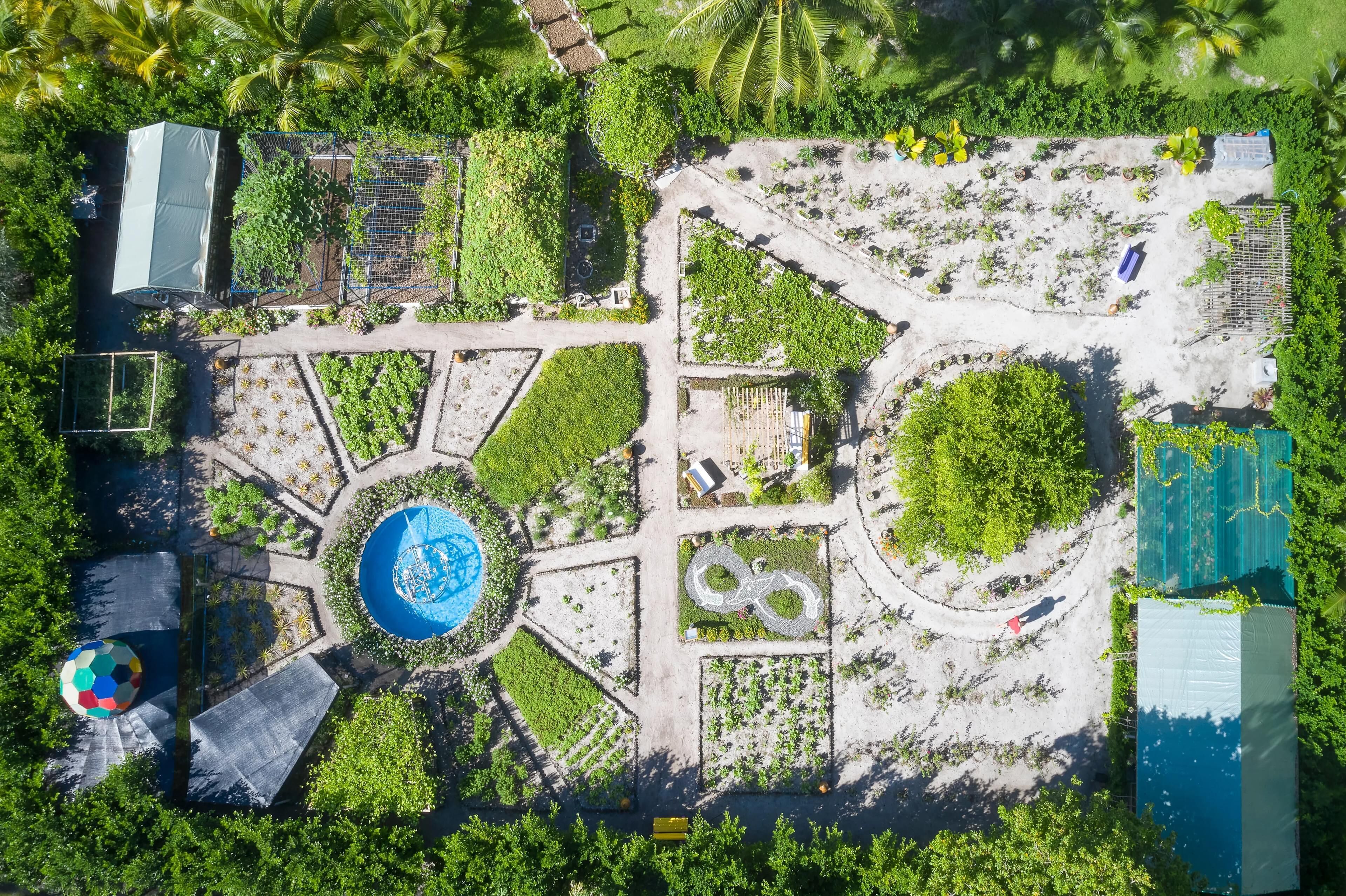 An aerial view of a landscaped area with pathways, green spaces, and a central circular feature.