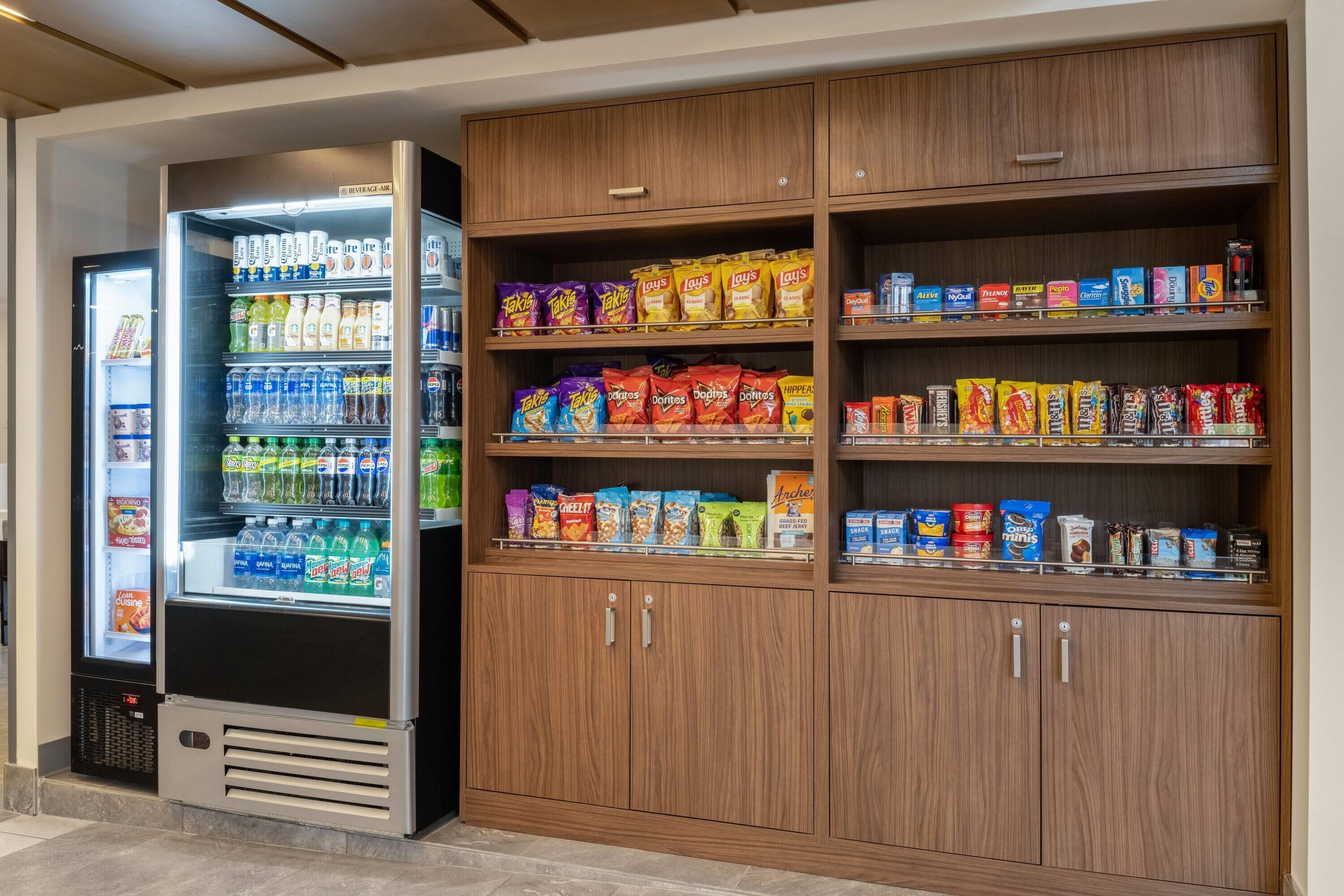 A vending machine and a snack shelf with various packaged goods.
