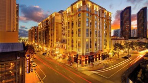 A multi-story hotel with a modern architectural design, featuring a prominent entrance and a well-lit street view.