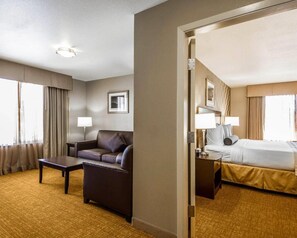 A hotel room with a bed, a desk, a chair, and a sofa. - Hotel Med Park, an Ascend Collection Hotel (Sacramento)