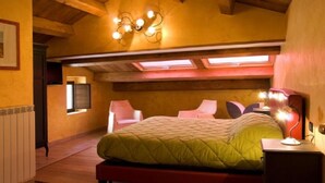Un dormitorio con cama, escritorio y silla. Se observa una ventana y una lámpara en el techo.