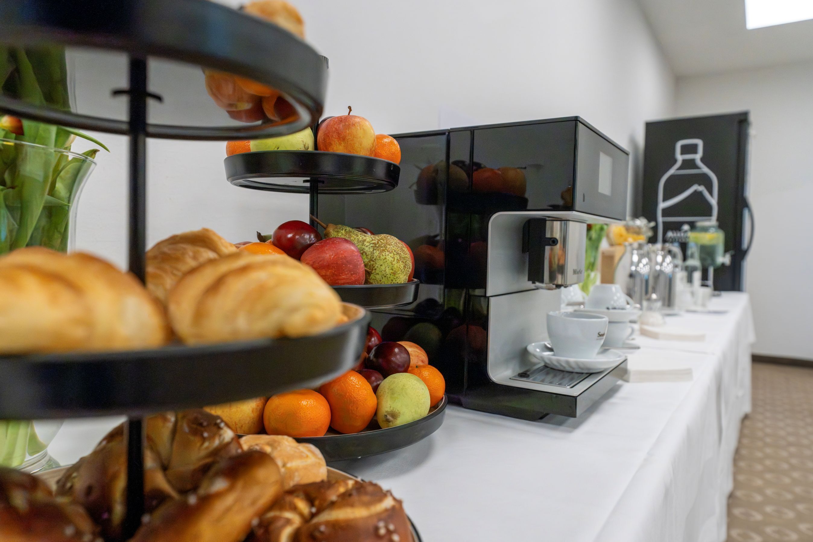 Un buffet proposant des pâtisseries, des fruits et un coin café.